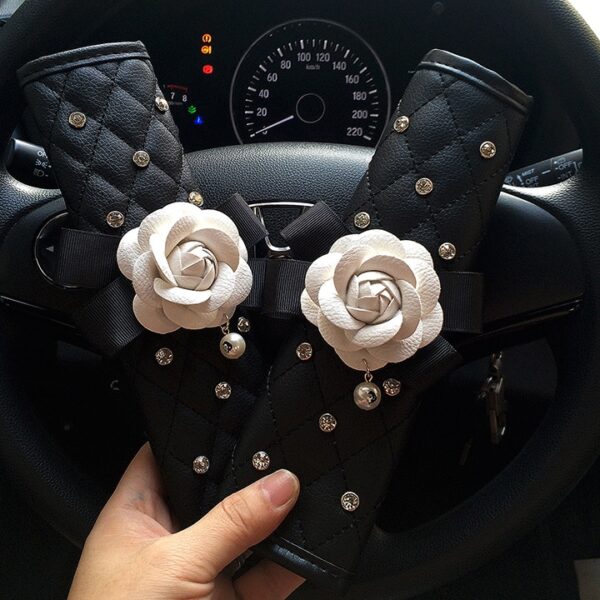 https://www.joopzy.com/wp-content/uploads/2021/01/Crystal-Rhinestones-Camellia-Flower-Car-Interior-Accessories-Women-Leather-Steering-Wheel-Cover-Hand-brake-Gear-Cover-5-600x600.jpg